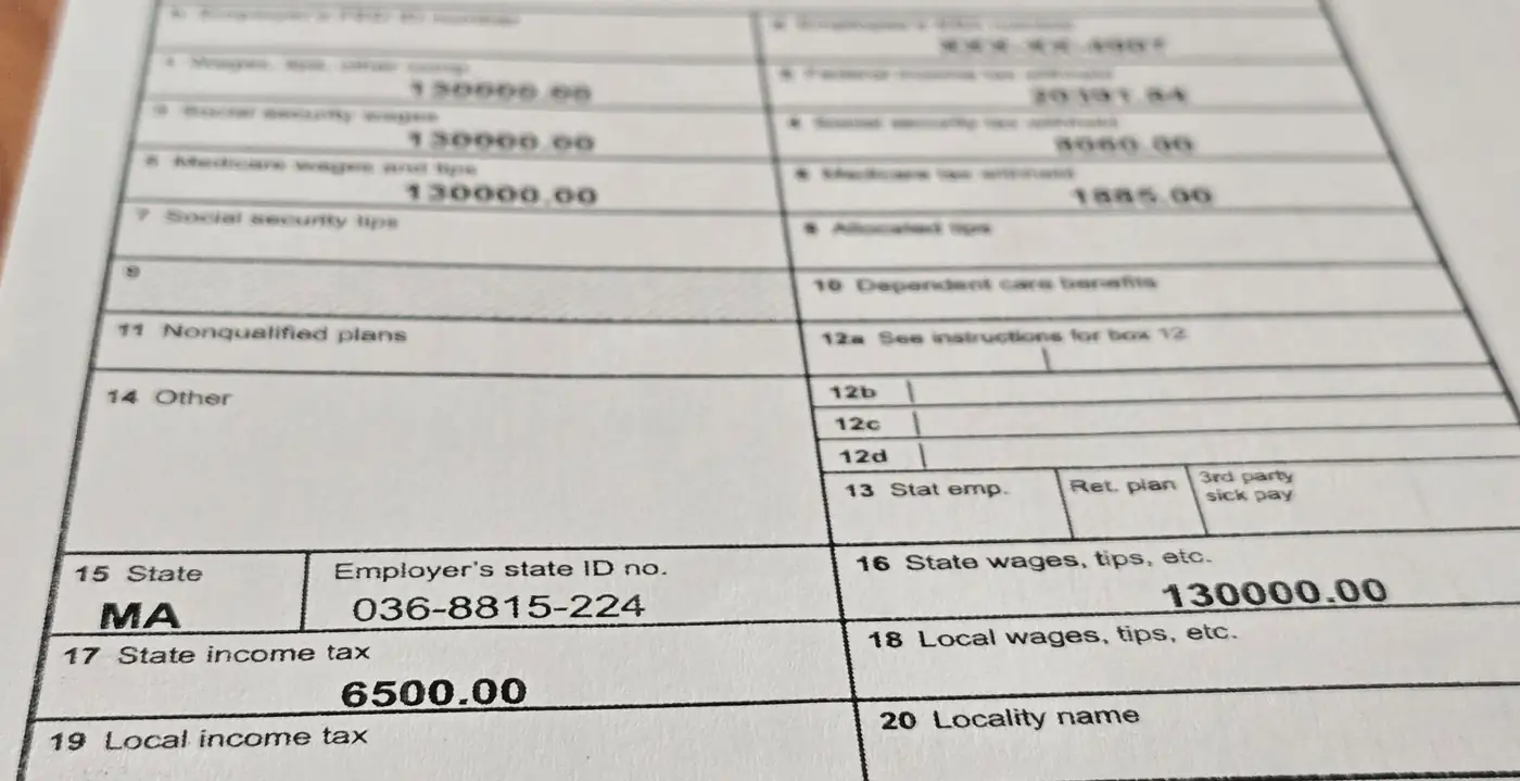 A printed 2025 Form W-2 with sample figures, showing $130,000 of wages in box 1, the same $130,000 repeated as Massachusetts state wages in box 16, and $6,500 of Massachusetts income tax withheld in box 17.